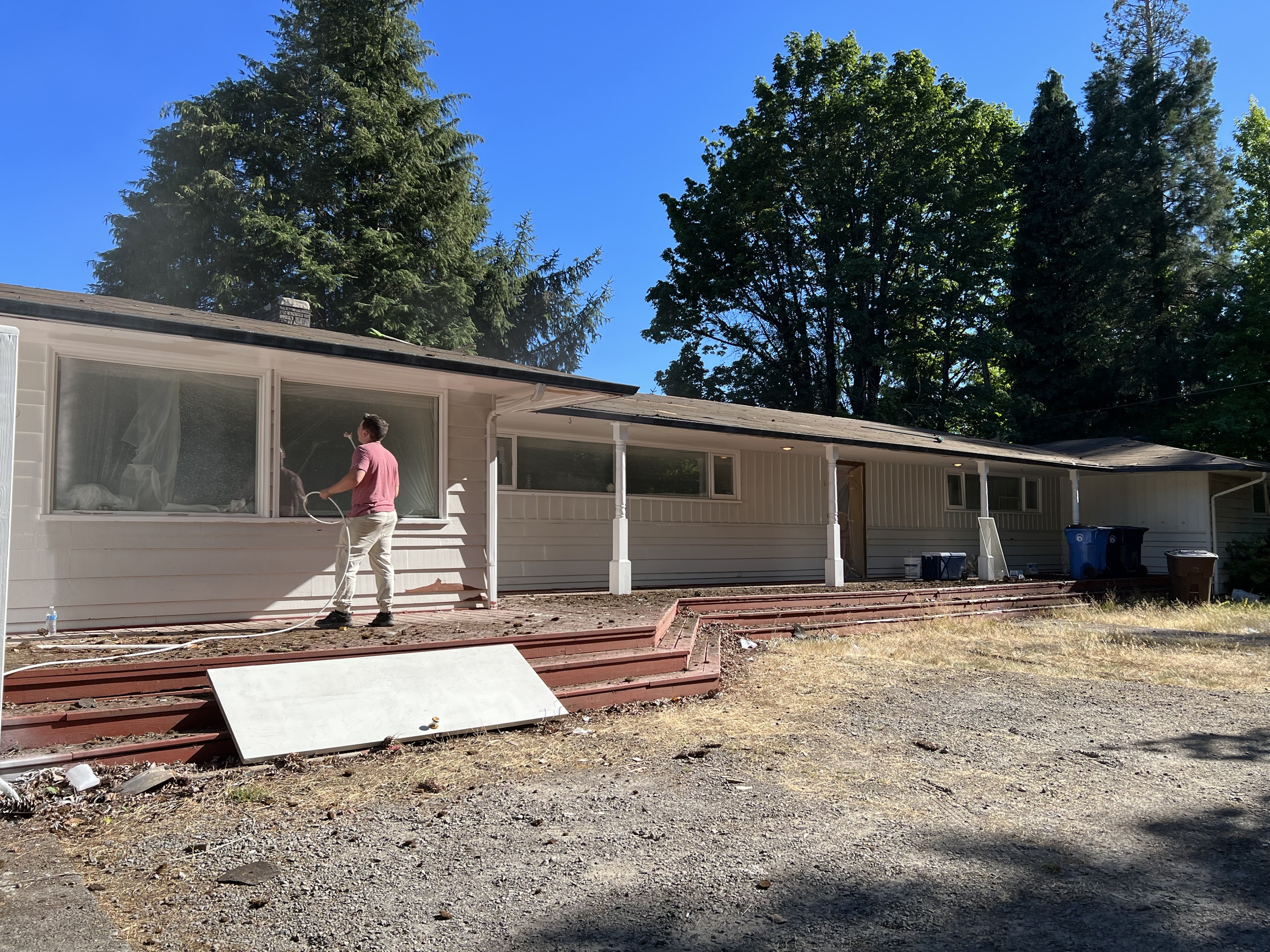Exterior prep and pressure washing in progress
